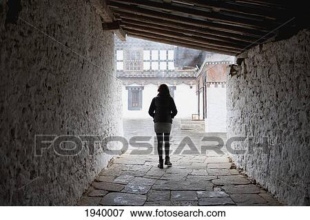 A Woman Walks Down A Stone Corridor At Trongsa Dzong; Trongsa District Bhutan View Large Photo Image Stock Photo - A Woman Walks Down A Stone Corridor At Trongsa Dzong; Trongsa District Bhutan. Fotosearch