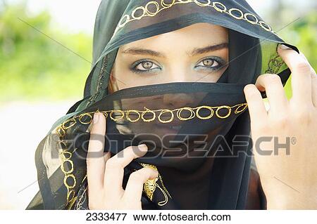 Stock Photo - A Woman's Eyes Peering Out From A Headscarf; Kauai, Hawaii, United States Of America. Fotosearch