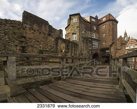 A Wooden Boardwalk And Railing Against An Old Stone Wall; Newcastle, Tyne And Wear, England View Large Photo Image Stock Photo - A Wooden Boardwalk And Railing Against An Old Stone Wall; Newcastle, Tyne And Wear, England. Fotosearch