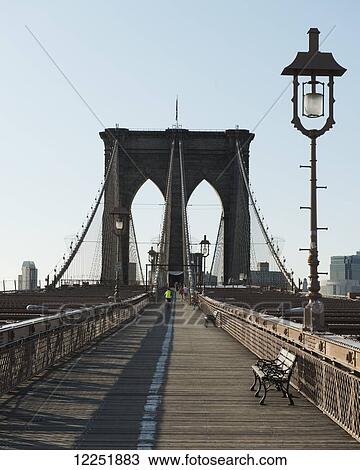 Stock Image - A wooden boardwalk on a bridge with bench and lamp post; New York City, New York, United States of America. Fotosearch
