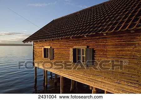 A wooden building raised on pilings in a lake; Herrsching, Bavaria, Germany View Large Photo Image Picture - A wooden building raised on pilings in a lake; Herrsching, Bavaria, Germany. Fotosearch