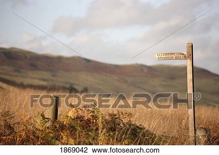 Stock Image - A Wooden Distance Sign On A Post. Fotosearch