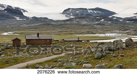 A Wooden House And Shed Stand Along A Fjord With A Dirt Road And Mountains In The Background; Highlands Norway View Large Photo Image Stock Photograph - A Wooden House And Shed Stand Along A Fjord With A Dirt Road And Mountains In The Background; Highlands Norway. Fotosearch