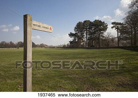 A Wooden Sign Pointing To An Historic Church; Coverham Yorkshire England View Large Photo Image Stock Photography - A Wooden Sign Pointing To An Historic Church; Coverham Yorkshire England. Fotosearch
