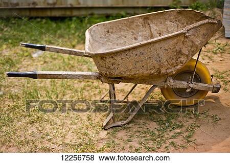 A worn and weathered wheelbarrow at the construction site of the Iranzi Clinic; Kigali, Rwanda View Large Photo Image Stock Photo - A worn and weathered wheelbarrow at the construction site of the Iranzi Clinic; Kigali, Rwanda. Fotosearch