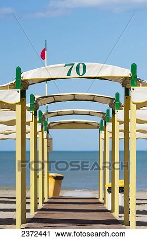 A Yellow And Green Structure Over A Walkway Leading To The Beach And Adriatic Sea; Rimini, Emilia-Romagna, Italy View Large Photo Image Stock Image - A Yellow And Green Structure Over A Walkway Leading To The Beach And Adriatic Sea; Rimini, Emilia-Romagna, Italy. Fotosearch