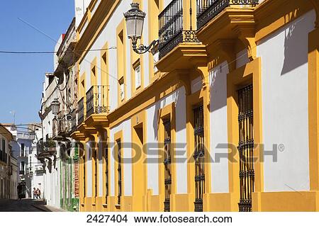 A yellow and white building with small balconies and lights; Tarifa, Andalusia, Spain View Large Photo Image Picture - A yellow and white building with small balconies and lights; Tarifa, Andalusia, Spain. Fotosearch