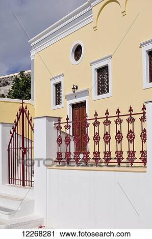 A yellow house with red door, gate and railing; Fira, Santorini, Cyclades, Greek Islands, Greece View Large Photo Image Stock Image - A yellow house with red door, gate and railing; Fira, Santorini, Cyclades, Greek Islands, Greece. Fotosearch