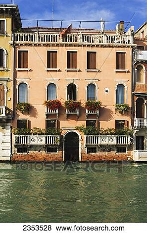 Stock Photo - A Yellow Residential Building Along The Grand Canal; Venice, Italy. Fotosearch