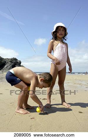 Stock Photography - A Young Boy And Girl On A Beach. Fotosearch