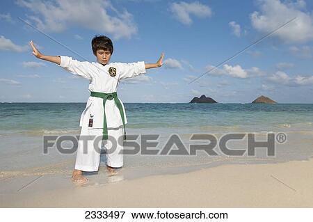 A young boy in a martial arts uniform on a beach; Honolulu, Oahu, Hawaii, United States of America View Large Photo Image Stock Photo - A young boy in a martial arts uniform on a beach; Honolulu, Oahu, Hawaii, United States of America. Fotosearch