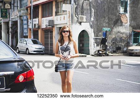 A young female tourist walks on the street in Georgetown, Little India and Chinatown areas; Penang, Malaysia View Large Photo Image Stock Image - A young female tourist walks on the street in Georgetown, Little India and Chinatown areas; Penang, Malaysia. Fotosearch
