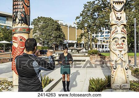 A young Indian ethnicity couple poses by totem poles at the Signs of Lekwungen interpretive walkway; Victoria, Vancouver Island, British Columbia View Large Photo Image Stock Image - A young Indian ethnicity couple poses by totem poles at the Signs of Lekwungen interpretive walkway; Victoria, Vancouver Island, British Columbia. Fotosearch