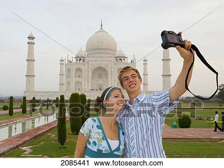 A Young Man And Woman Photograph Themselves With The Taj Mahal In The Background; Agra Uttar Pradesh India View Large Photo Image Stock Image - A Young Man And Woman Photograph Themselves With The Taj Mahal In The Background; Agra Uttar Pradesh India. Fotosearch