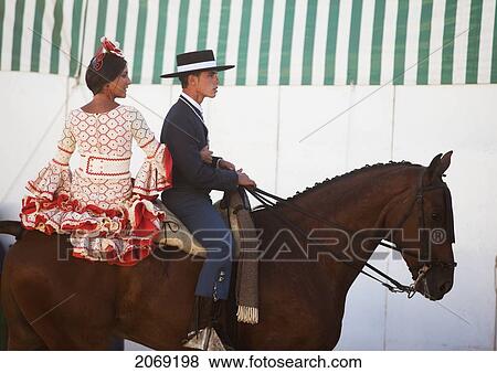 A Young Man And Woman Ride On A Horse In Feria; Tarifa Cadiz Andalusia Spain View Large Photo Image Stock Photo - A Young Man And Woman Ride On A Horse In Feria; Tarifa Cadiz Andalusia Spain. Fotosearch
