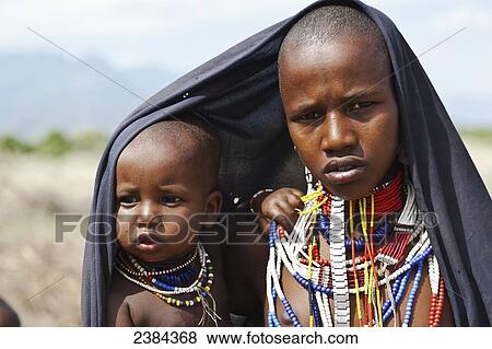 A young man and young child wearing colourful beaded jewelry; Omo Valley, Ethiopia View Large Photo Image Stock Photo - A young man and young child wearing colourful beaded jewelry; Omo Valley, Ethiopia. Fotosearch