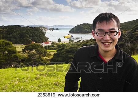 A Young Man Poses In Front Of The Main Island Port; Urupukapuka Island, New Zealand View Large Photo Image Stock Photo - A Young Man Poses In Front Of The Main Island Port; Urupukapuka Island, New Zealand. Fotosearch