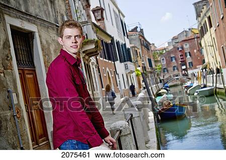 A Young Man Standing At A Railing On A Canal; Venice Italy View Large Photo Image Stock Image - A Young Man Standing At A Railing On A Canal; Venice Italy. Fotosearch