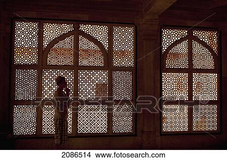 Picture - A Young Man Stands In Front Of An Ornate Screened Window; Jaipur Rajasthan India. Fotosearch