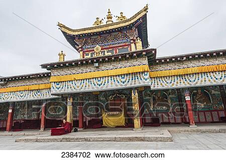 Stock Image - A young monk reading the prayer at at Longwu monastery of Tibet; Tibet, China. Fotosearch