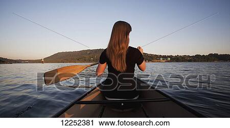 A young woman canoeing at sunset; Vancouver, British Columbia, Canada View Large Photo Image Stock Image - A young woman canoeing at sunset; Vancouver, British Columbia, Canada. Fotosearch