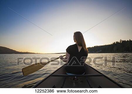 A young woman canoeing at sunset; Vancouver, British Columbia, Canada View Large Photo Image Stock Photograph - A young woman canoeing at sunset; Vancouver, British Columbia, Canada. Fotosearch