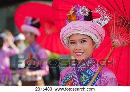 Stock Image - A Young Woman Dressed For The Chiang Mai Flower Festival Parade; Chiang Mai Thailand. Fotosearch