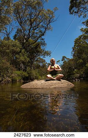 A young woman in a creek doing yoga pose; Threadbo, New South Wales, Australia View Large Photo Image Stock Image - A young woman in a creek doing yoga pose; Threadbo, New South Wales, Australia. Fotosearch