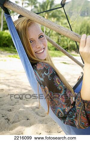 A young woman in a hammock on Tunnel's Beach; Kauai, Hawaii, United States of America View Large Photo Image Stock Photo - A young woman in a hammock on Tunnel's Beach; Kauai, Hawaii, United States of America. Fotosearch