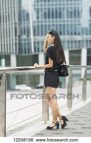 A young woman in the business district; Xiamen, China View Large Photo Image Stock Photograph - A young woman in the business district; Xiamen, China. Fotosearch