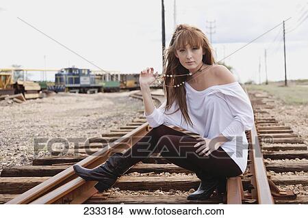 A young woman poses on train tracks; Honolulu, Oahu, Hawaii, United States of America View Large Photo Image Picture - A young woman poses on train tracks; Honolulu, Oahu, Hawaii, United States of America. Fotosearch
