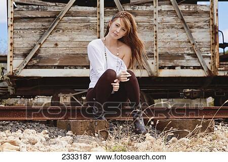 A young woman poses on train tracks; Honolulu, Oahu, Hawaii, United States of America View Large Photo Image Stock Photo - A young woman poses on train tracks; Honolulu, Oahu, Hawaii, United States of America. Fotosearch
