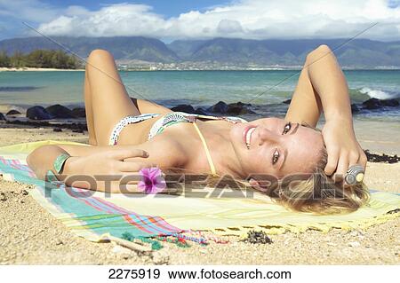 A young woman posing on the beach of an hawaiian island; Maui, Hawaii, United States of America View Large Photo Image Stock Photo - A young woman posing on the beach of an hawaiian island; Maui, Hawaii, United States of America. Fotosearch