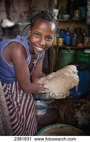 A young woman preparing the dough to make the staple food, Injera; Ethiopia View Large Photo Image Stock Image - A young woman preparing the dough to make the staple food, Injera; Ethiopia. Fotosearch