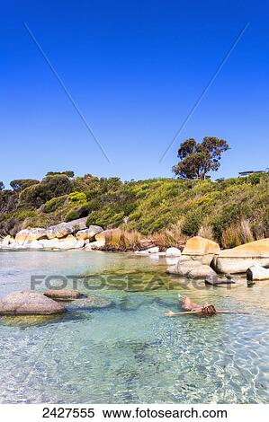 A young woman swims at Bay of Fires beach; Tasmania, Australia View Large Photo Image Stock Photography - A young woman swims at Bay of Fires beach; Tasmania, Australia. Fotosearch