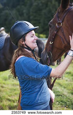 A Young Woman Talks With A Horse At Blue Duck Lodge, In The Whanganui National Park; Whakahoro, New Zealand View Large Photo Image Stock Photo - A Young Woman Talks With A Horse At Blue Duck Lodge, In The Whanganui National Park; Whakahoro, New Zealand. Fotosearch