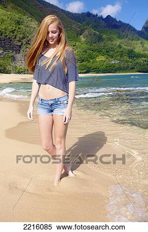 A young woman walking on Tunnel's beach; Kauai, Hawaii, United States of America View Large Photo Image Stock Photography - A young woman walking on Tunnel's beach; Kauai, Hawaii, United States of America. Fotosearch