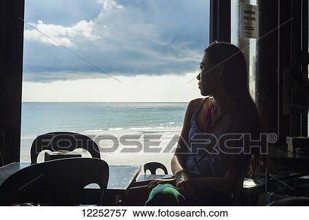 A young woman watching the views from a restaurant, Borakay beach; Borakay, Panay, Philippines View Large Photo Image Stock Photo - A young woman watching the views from a restaurant, Borakay beach; Borakay, Panay, Philippines. Fotosearch