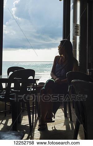 A young woman watching the views from a restaurant, Borakay beach; Borakay, Panay, Philippines View Large Photo Image Stock Photo - A young woman watching the views from a restaurant, Borakay beach; Borakay, Panay, Philippines. Fotosearch