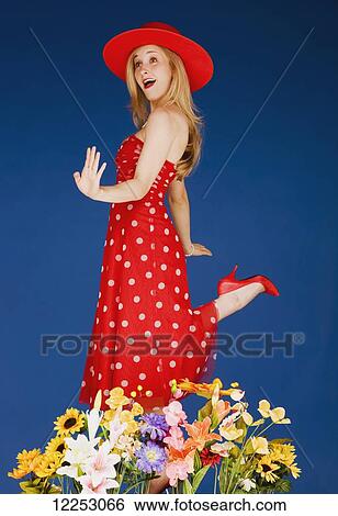 A young woman wearing red and dancing in flowers; Edmonton, Alberta, Canada View Large Photo Image Stock Photograph - A young woman wearing red and dancing in flowers; Edmonton, Alberta, Canada. Fotosearch