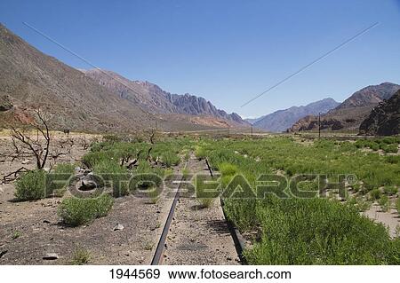 Stock Photo - Abandoned tracks and station of the Ferrocarril Transandino (Transandine Railway) along the Mendoza River, Mendoza, Argentina. Fotosearch