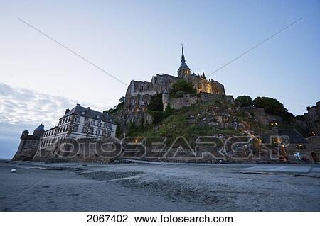 Stock Image - Abbey Of Mont-Saint-Michel At Dusk, As Seen From The Southwest, France. Fotosearch