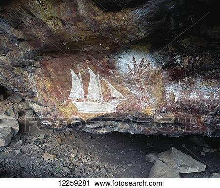 Stock Image - Aboriginal rock art in Arnhem Land depicting the arrival of the first white ships; Northern Territory, Australia. Fotosearch