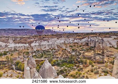 Abundance of hot air balloons over the rugged landscape of Honey Valley; Cappadocia, Turkey View Large Photo Image Stock Photograph - Abundance of hot air balloons over the rugged landscape of Honey Valley; Cappadocia, Turkey. Fotosearch
