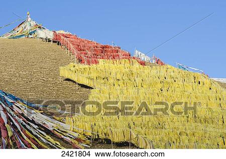Picture - Abundance of prayer flags on a mountain slope at a Tibetan monastery near Hot Spring city; Madoi County, Tibet. Fotosearch