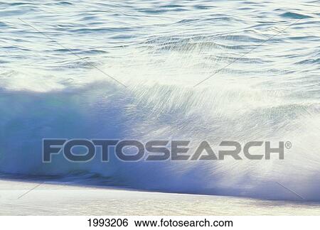 Stock Photograph - Action Of Crashing White Shoreline Wave, Blurred.. Fotosearch