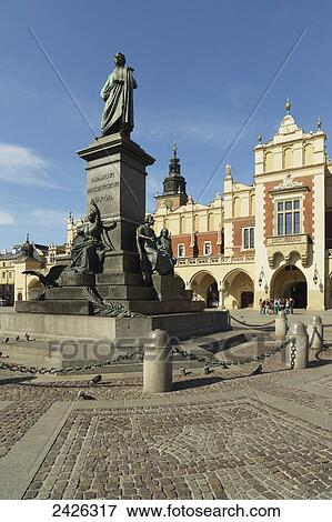 Stock Photo - Adam Mickiewicz Monument and Cloth Hall, Old Town Market Square; Krakow, Poland. Fotosearch