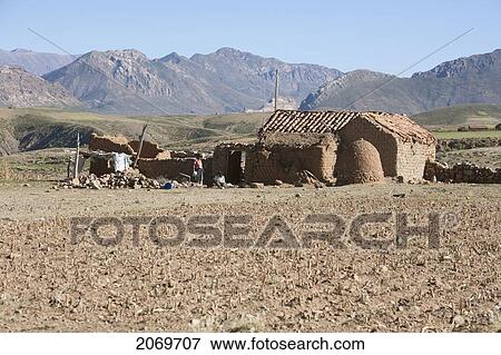 Stock Photo - Adobe Hut And Farm Fields Along The Road Between Sucre And Potos. Fotosearch