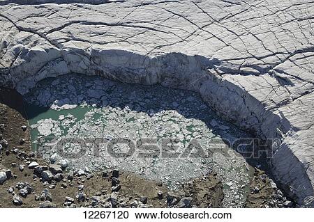 Aerial view looking down onto a piece of the Kaskawalsh Glacier as it melts into a small pond full of ice, Kluane National Park; Yukon, Canada View Large Photo Image Stock Image - Aerial view looking down onto a piece of the Kaskawalsh Glacier as it melts into a small pond full of ice, Kluane National Park; Yukon, Canada. Fotosearch