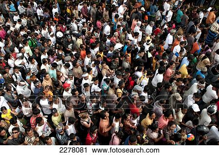 Stock Image - Aerial view of a crown dancing and singing; Bali. Fotosearch